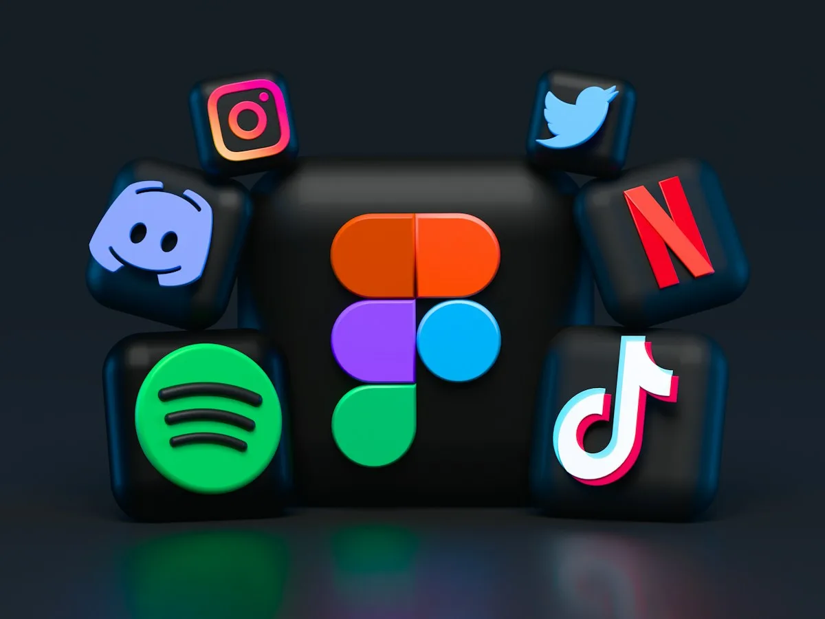 Content creator editing video on a computer with multiple screens